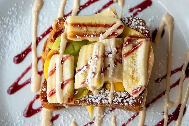 Tropical French toast with banana, pineapple and mango