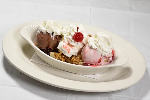 A sundae with whipped cream and a cherry