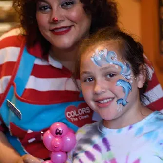 Colors the Clown with a child whose face is painted