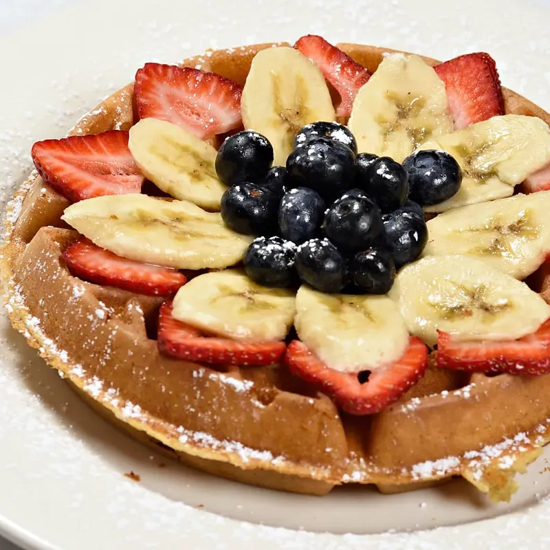 Belgian waffle with strawberries, bananas and blueberries